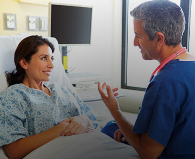 Doctor talking with patient in hospital room